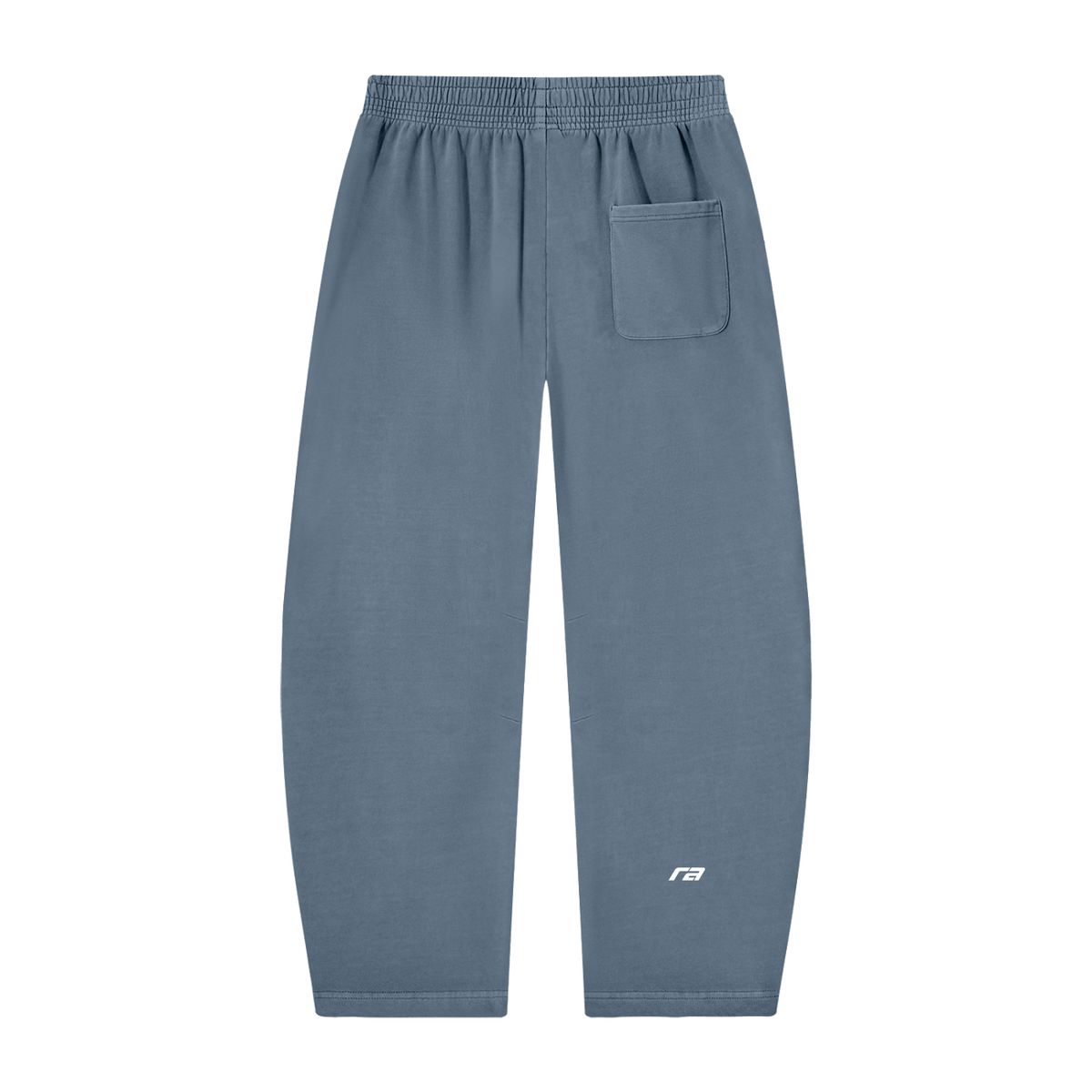 A pair of dusty slate blue sweatpants with an elastic waistband, a side pocket on the right leg, and a small white logo on the lower left leg, shown against a plain white background.