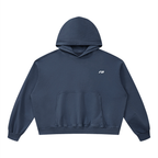 A navy blue cropped hoodie with a small white stylized logo on the left chest, displayed flat against a solid white background.