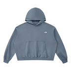 A slate blue cropped hoodie with a small white stylized logo on the left chest, displayed flat against a solid white background.