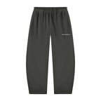 Black sweatpants with an elastic waistband and a small white script logo on the upper left thigh, shown against a plain white background.