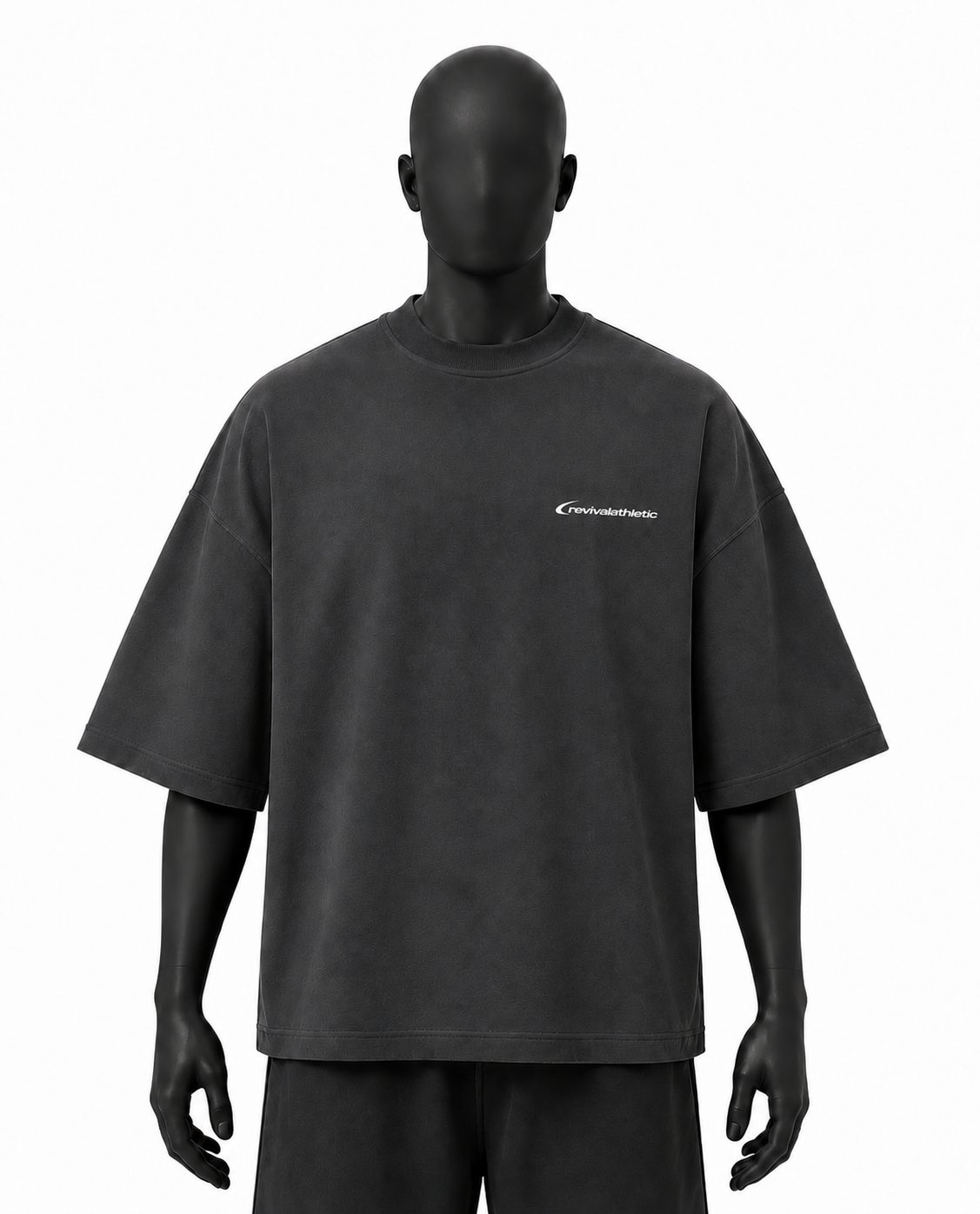 A dark charcoal gray oversized short-sleeve t-shirt displayed on a matte black mannequin against a plain white background. The shirt features a small white script logo on the left chest.