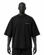 A black oversized short-sleeve t-shirt with a small white 'REVIVALATHLETIC' logo on the left chest, displayed on a black mannequin against a white background.