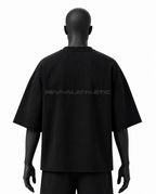 A black short-sleeve t-shirt shown from the back on a black mannequin, featuring the brand name 'REVIVALATHLETIC' printed in a subtle dark gray across the upper back.