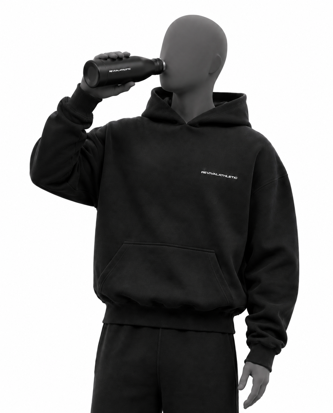A black hoodie with a small white 'REVIVALATHLETIC' logo on the chest, shown on a gray mannequin wearing matching black sweatpants. The mannequin is holding a black bottle to its eye against a plain white background.