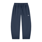 A pair of navy blue athletic jogger pants with an elastic waistband and a small white logo on the left thigh, shown against a plain white background.